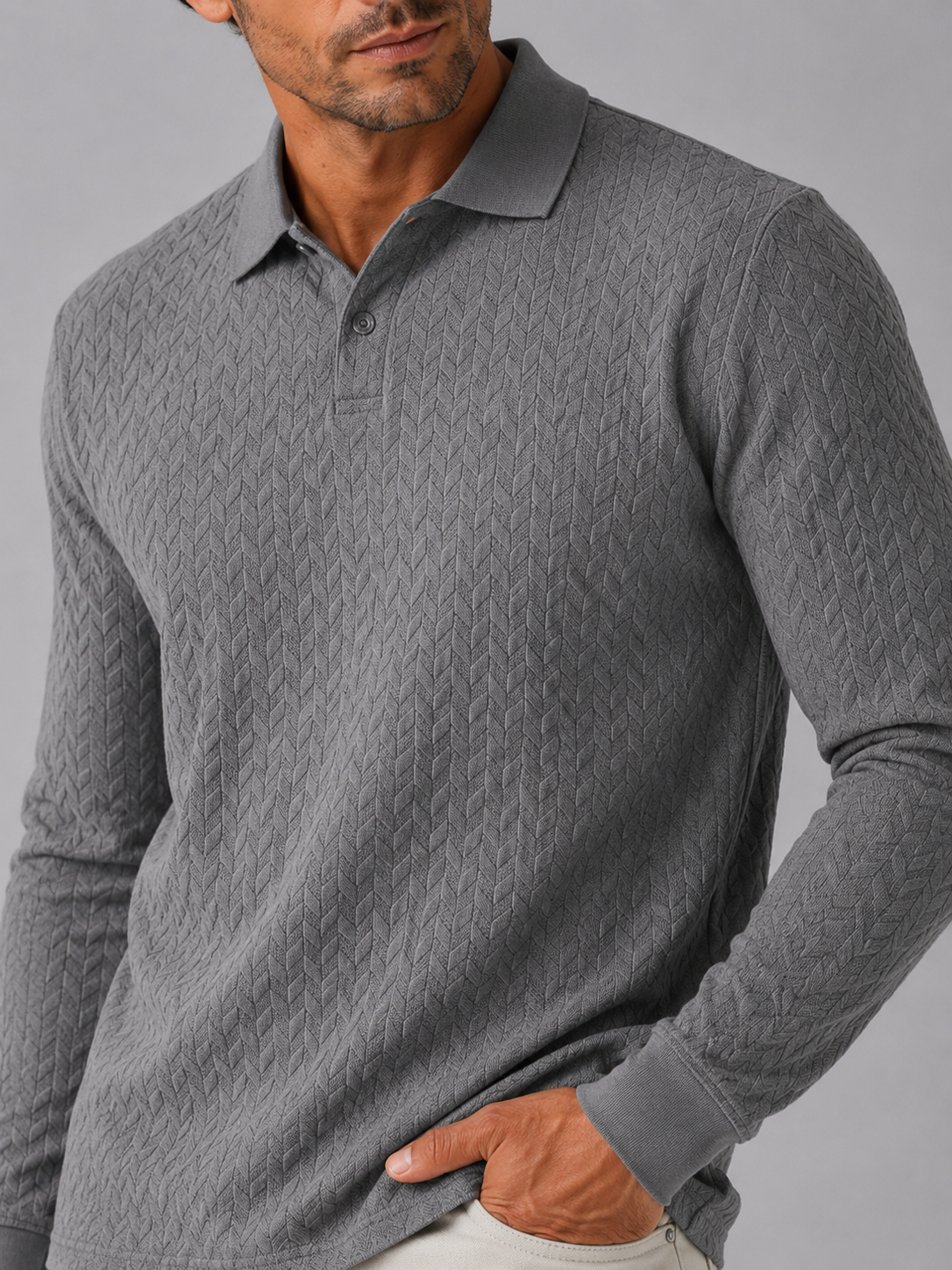 Close up of gray knit polo shirt showing soft textured fabric and refined collar detail