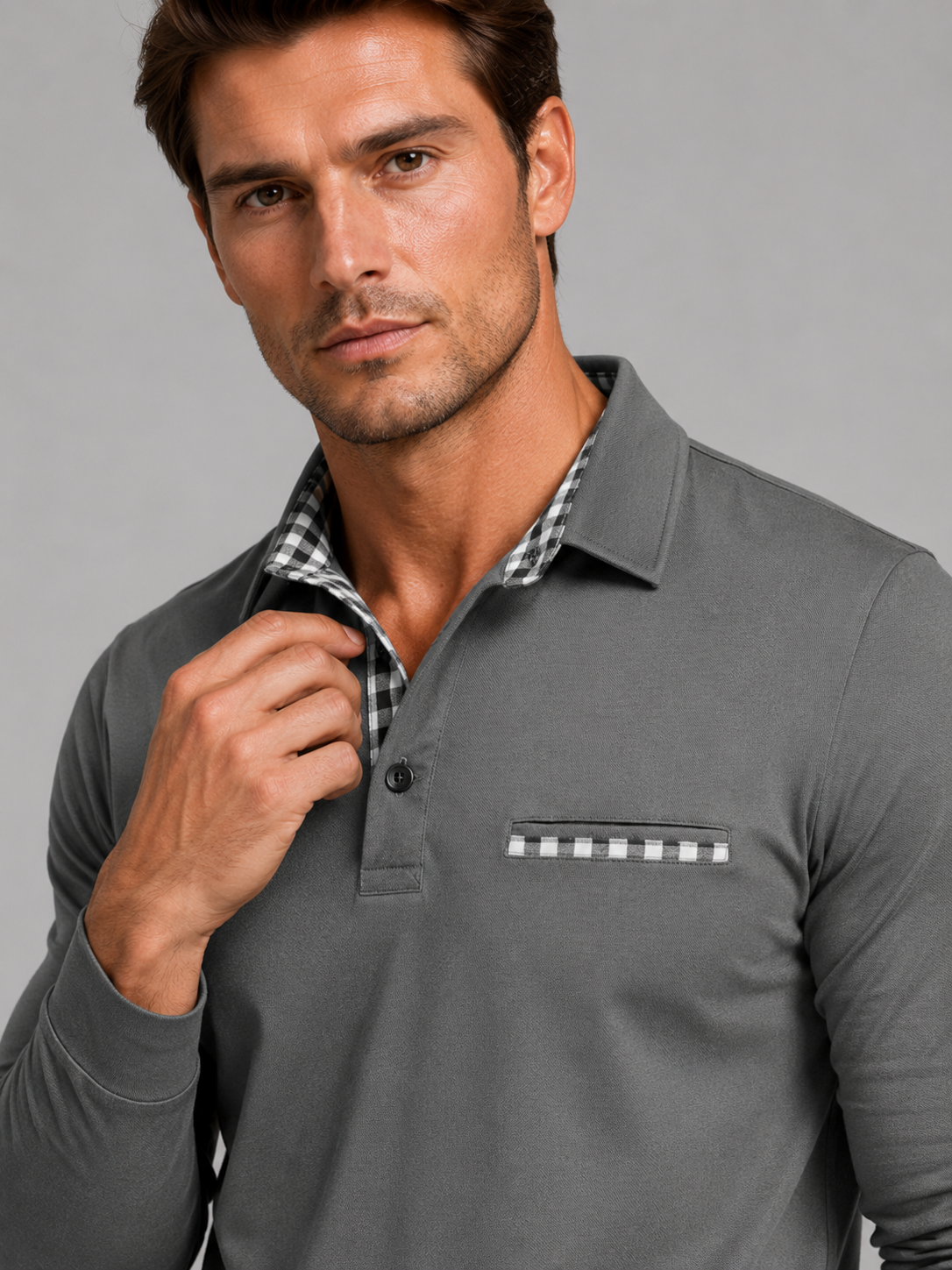 Close up of gray polo shirt showing plaid panel detail, soft fabric, and classic collar