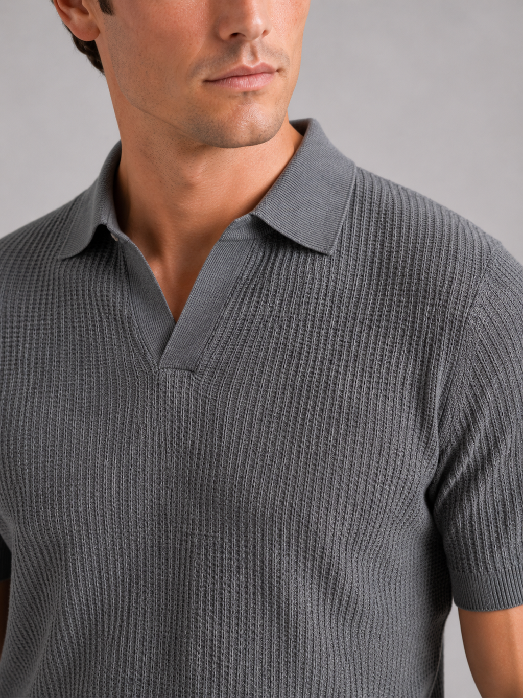 Close up of gray knit polo showing soft breathable fabric and refined collar detail