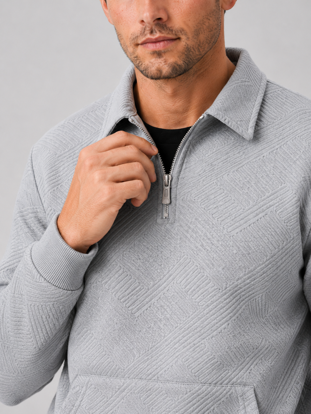 Close up of gray quarter zip sweater showing soft knit texture and refined zipper collar detail