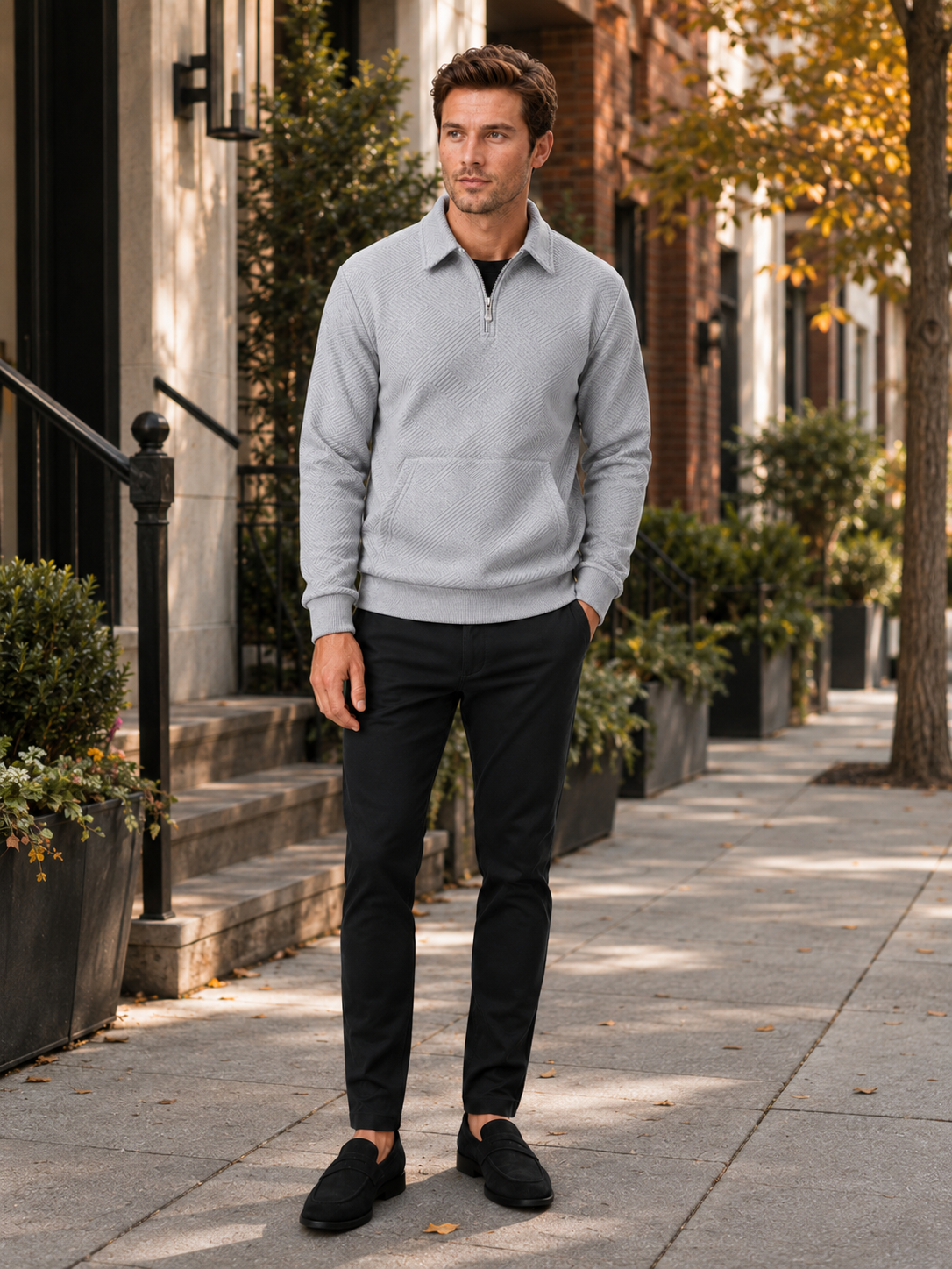 Man styling gray quarter zip sweater in a clean outdoor and everyday lifestyle outfit