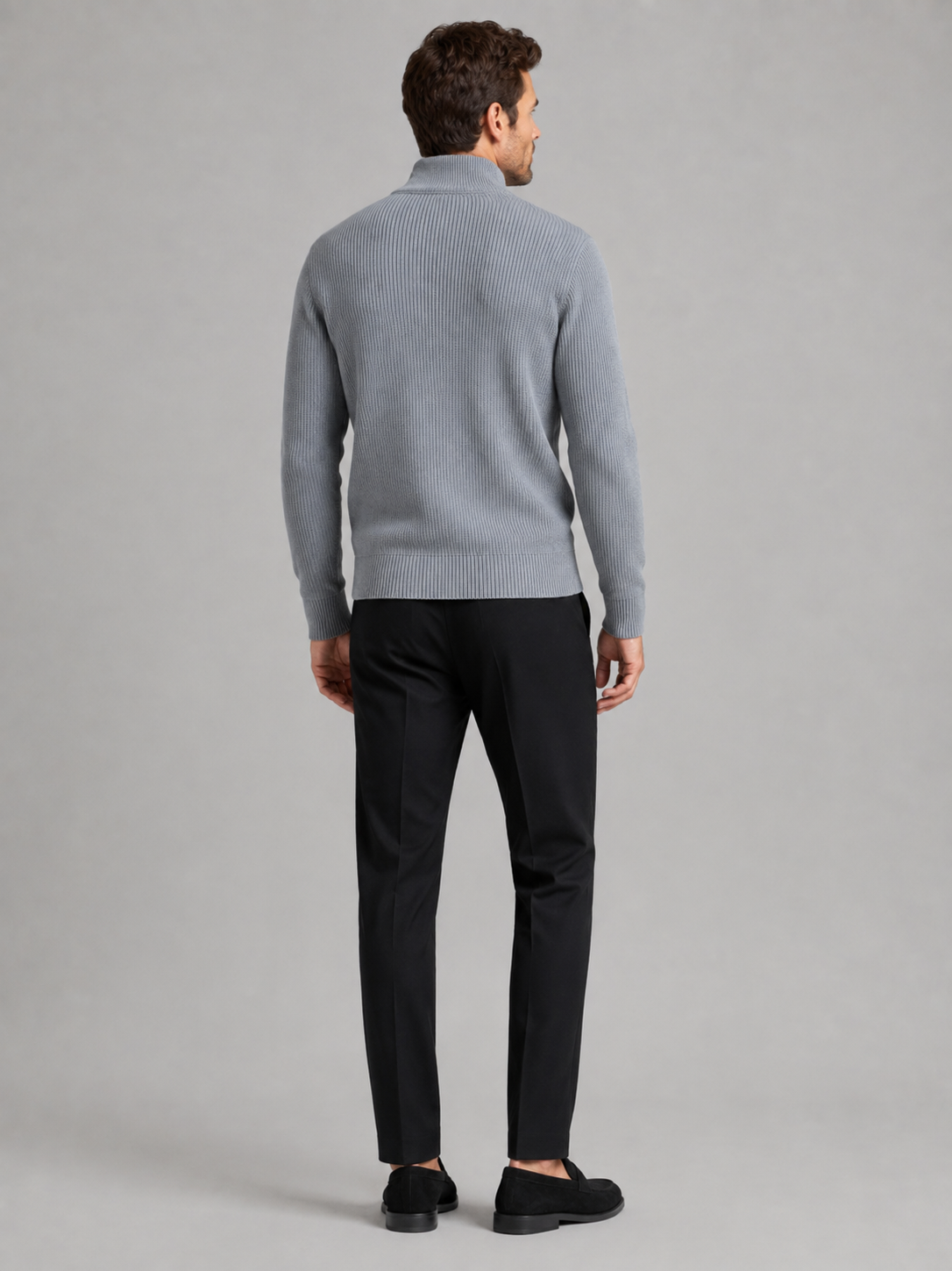 Back view of a man wearing a gray ribbed knit cardigan showing the slim fit, long sleeves, and textured knit construction