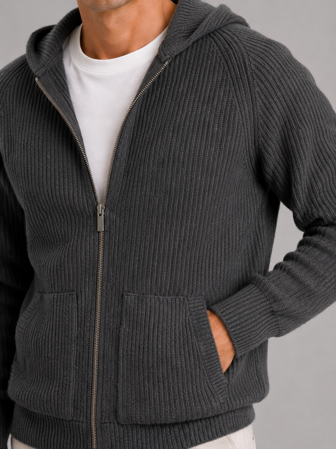 Close up of gray merino wool cardigan showing thick knit texture and zipper detail
