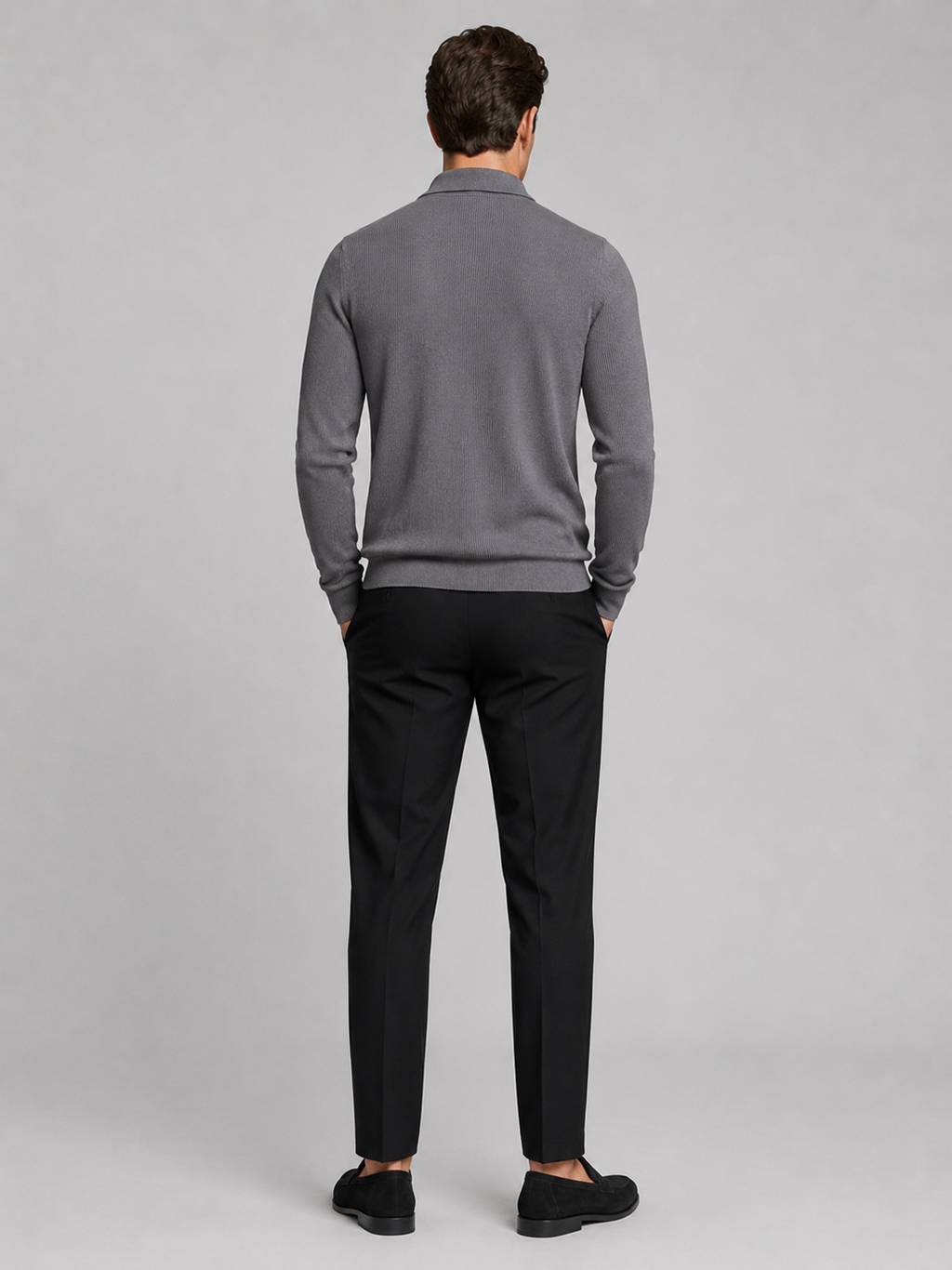 Back view of a man wearing a gray quarter zip polo showing the long sleeves, structured collar, and comfortable fall fit