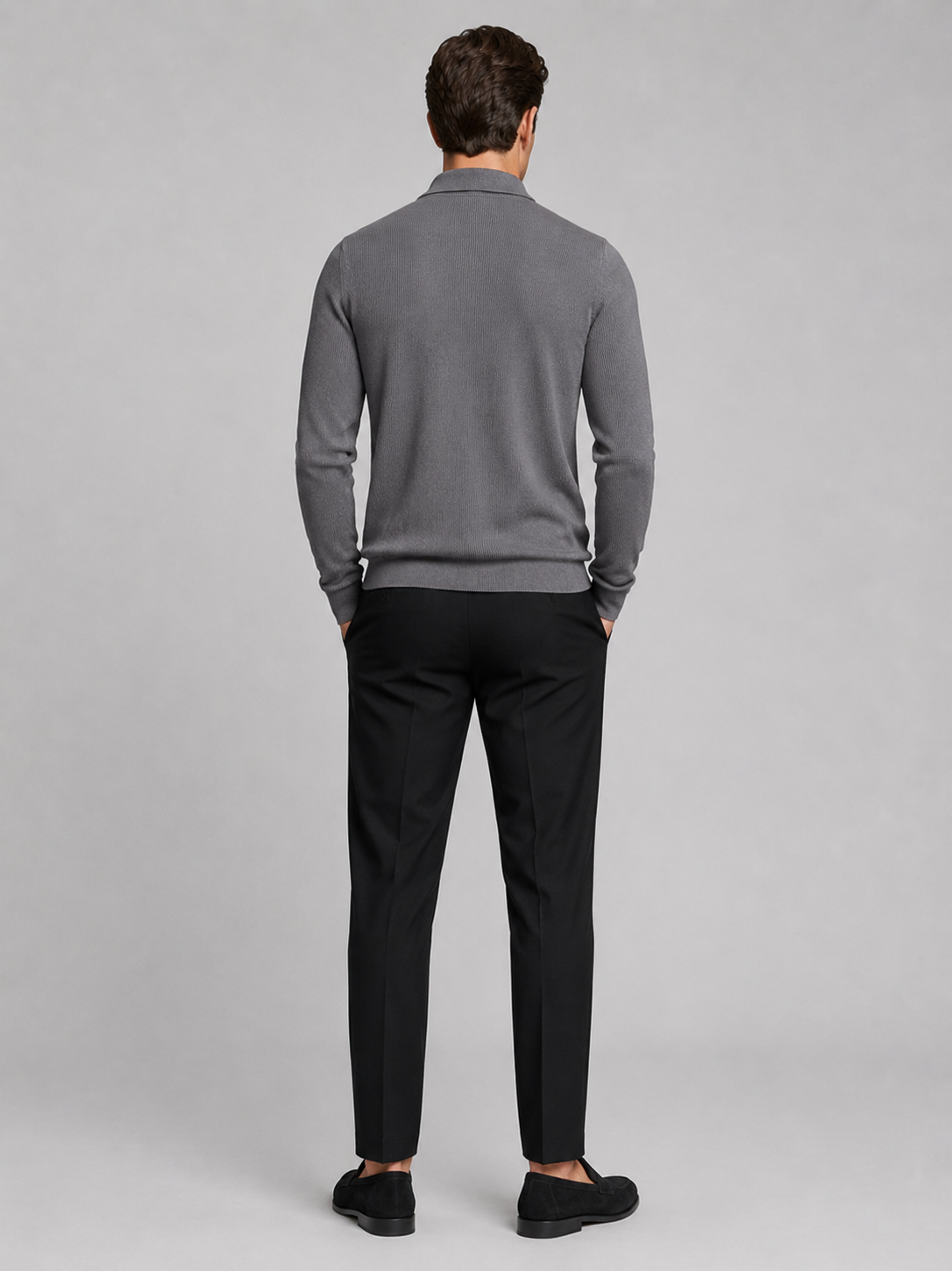 Back view of a man wearing a gray quarter zip polo showing the long sleeves, structured collar, and comfortable fall fit