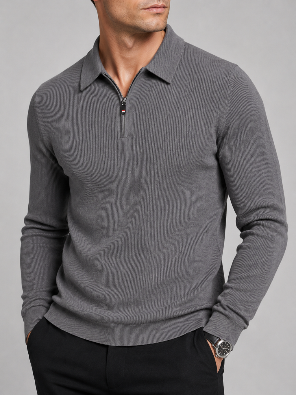 Close-up of a gray quarter zip long sleeve polo showing the zipper closure, lapel collar, soft fabric texture, cuffs, hem, and stitching