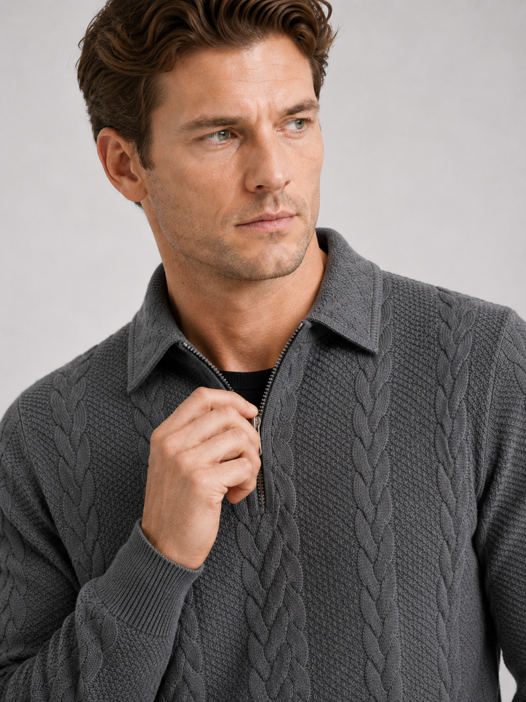 Close up of gray quarter zip sweater showing soft knit texture, turn down collar, and zipper detail