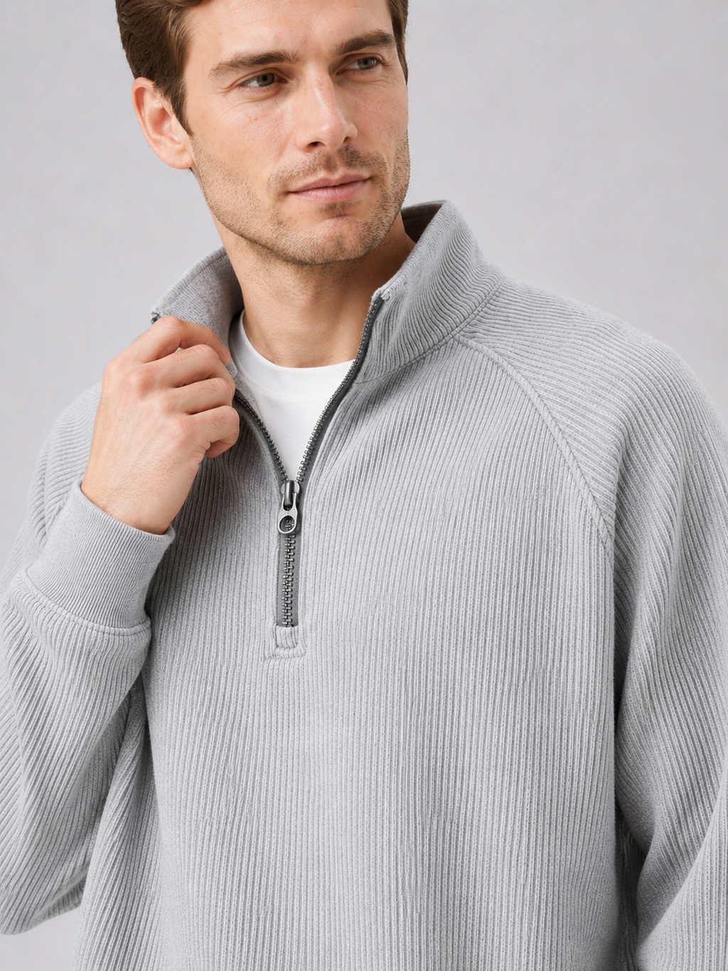 Close up of gray quarter zip sweater showing soft knit texture and stand collar zipper detail
