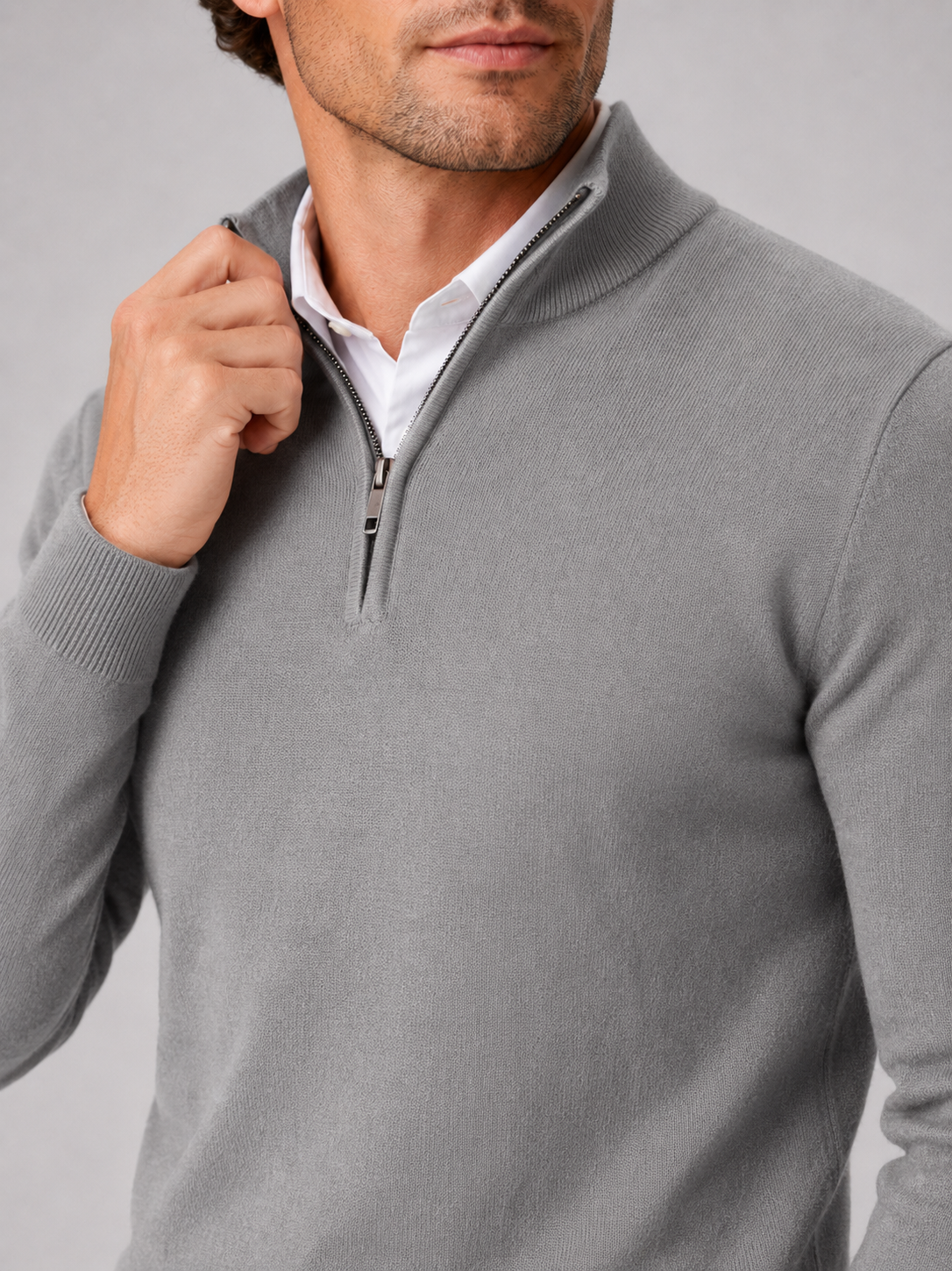Close up of gray quarter zip sweater showing soft knit texture and mock neck zipper detail