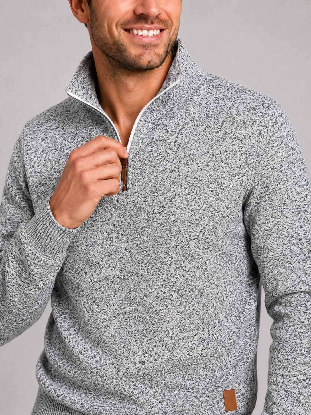 Close up of gray quarter zip sweater showing soft knit texture and stand collar zipper detail