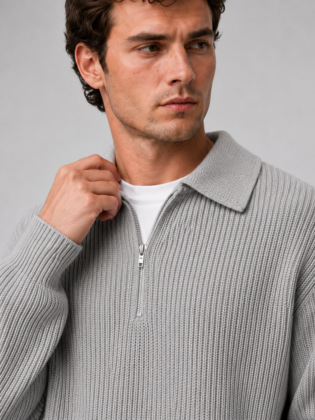 Close up of gray quarter zip polo sweater showing soft knit texture and turn down collar zipper detail