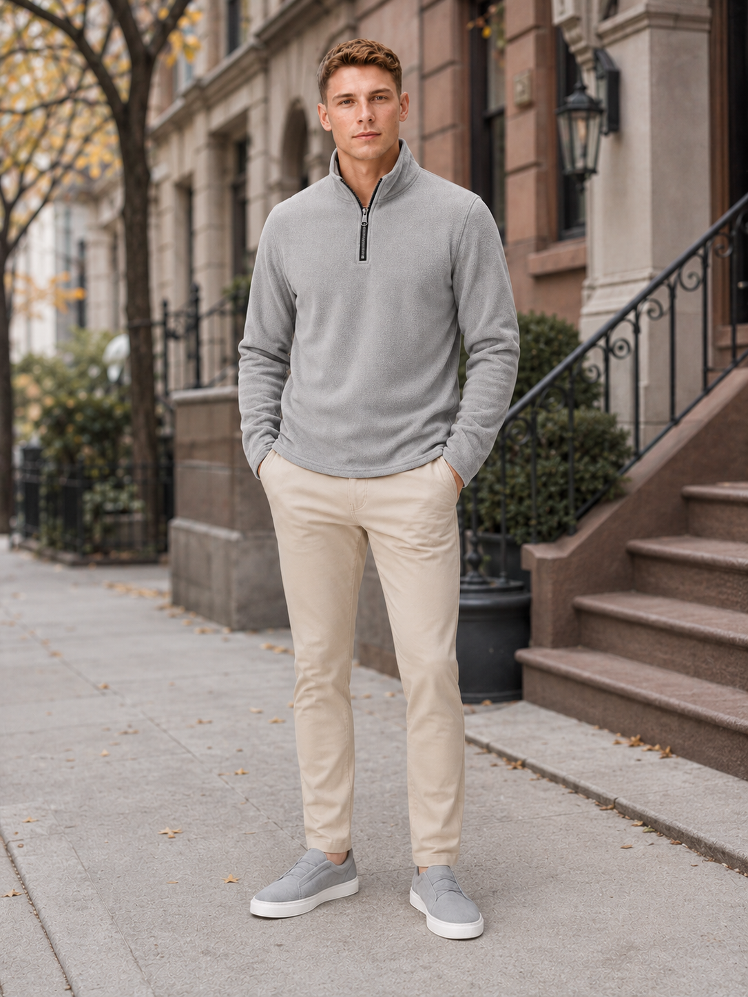 Man styling gray quarter zip fleece sweater in a clean outdoor and winter lifestyle outfit