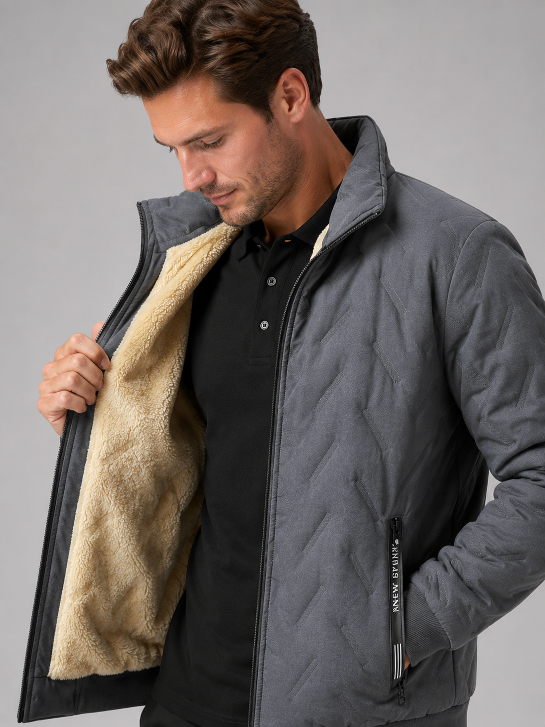 Close up of gray quilted jacket showing insulated quilted stitching, stand collar, and zip front detail