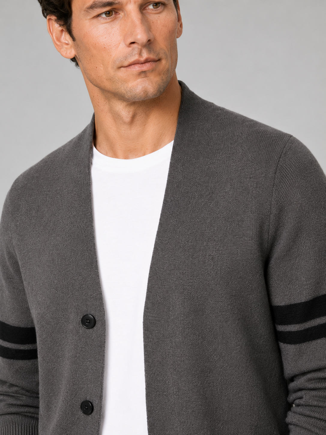 Close up of brown striped cardigan showing soft knit texture and color block pattern detail