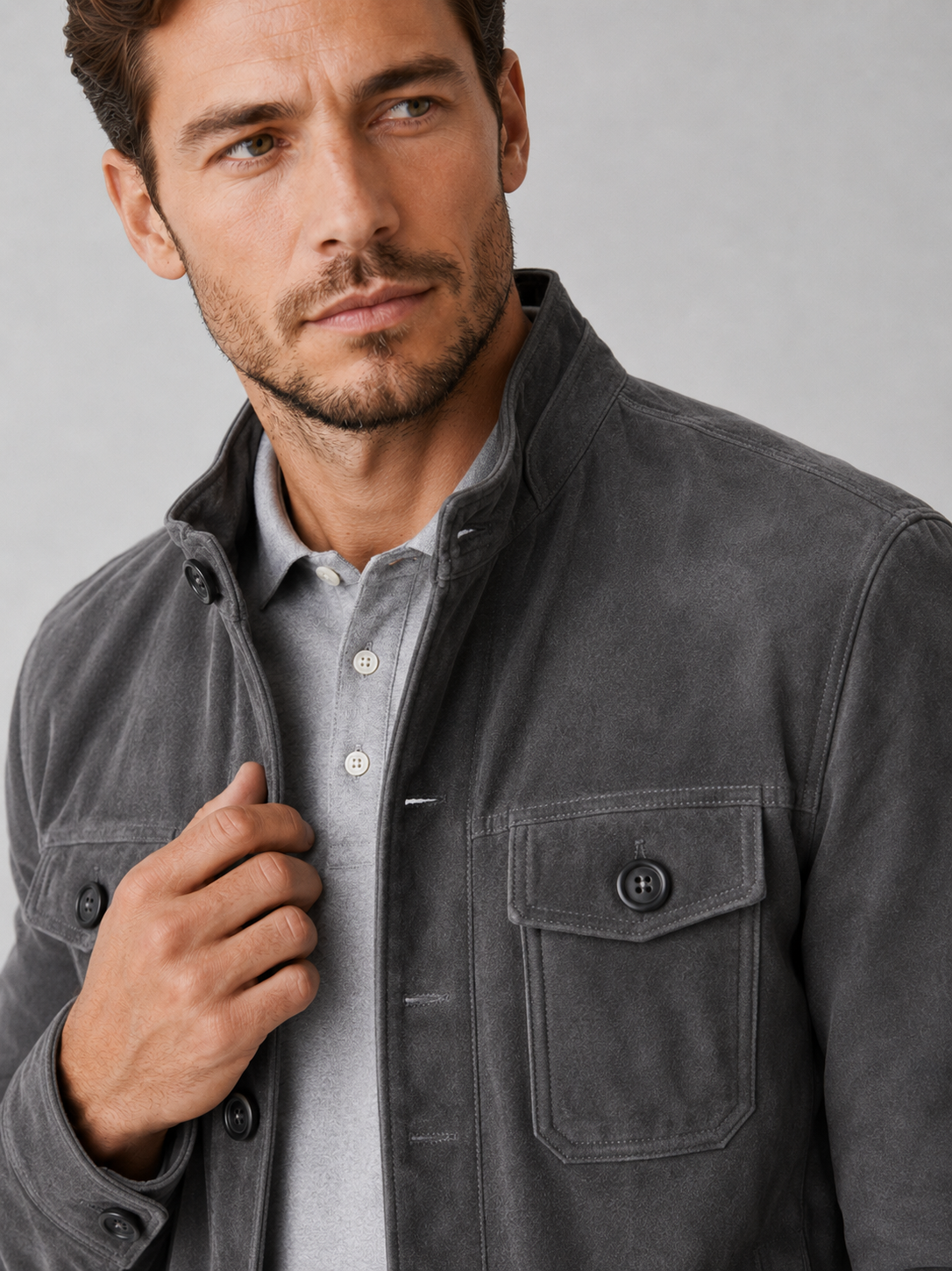 Close up of gray suede chore jacket showing soft brushed texture, button front, and utility pocket detail