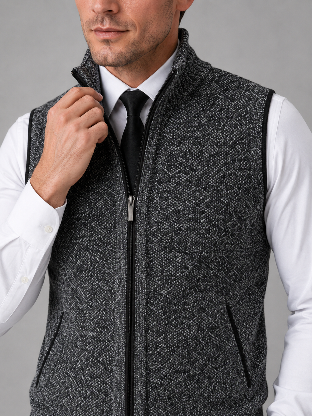 Close up of gray full zip sweater vest showing soft knit texture and stand collar zipper detail