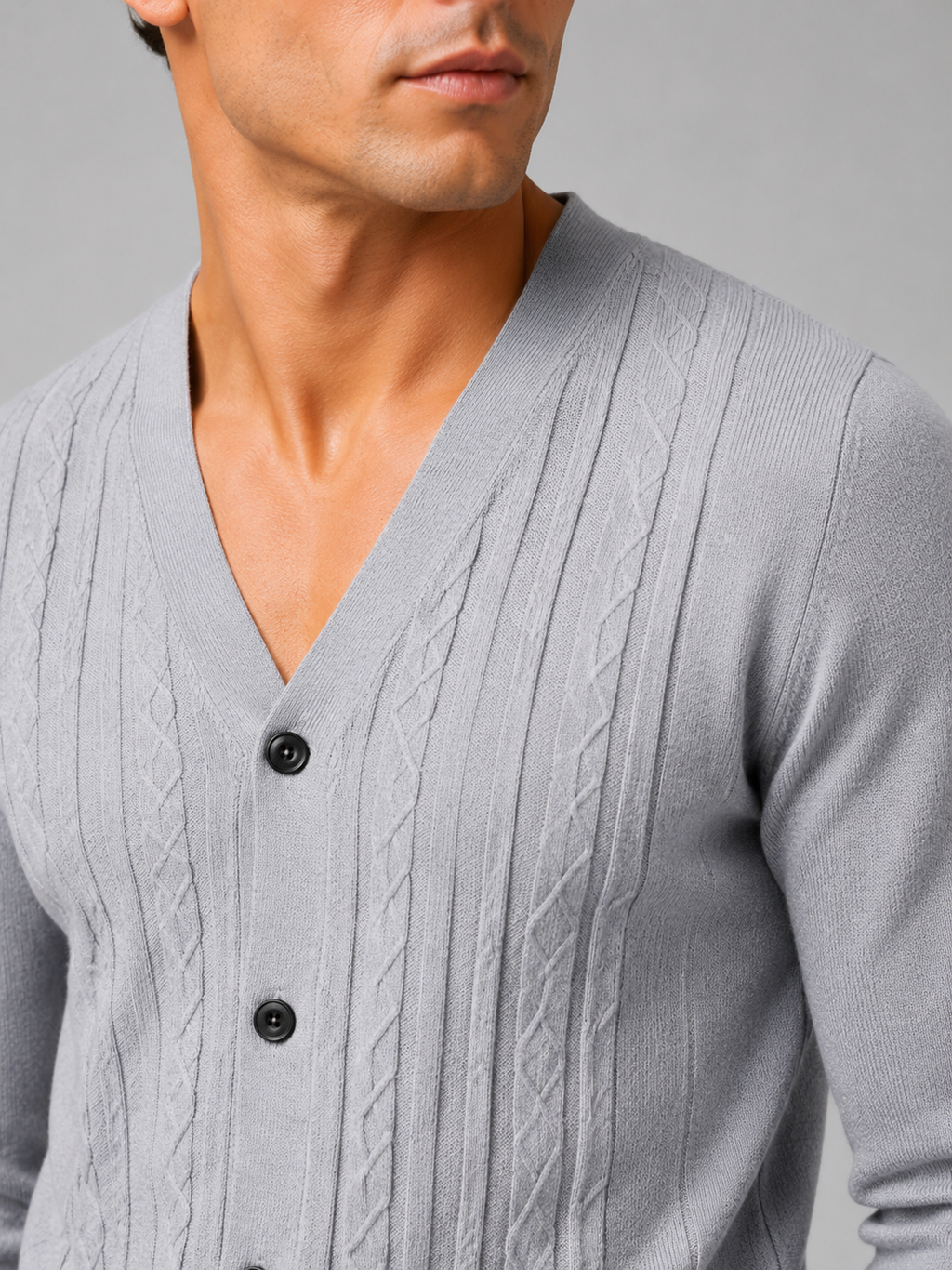 Close up of gray knit cardigan showing soft lightweight texture and refined button front detail