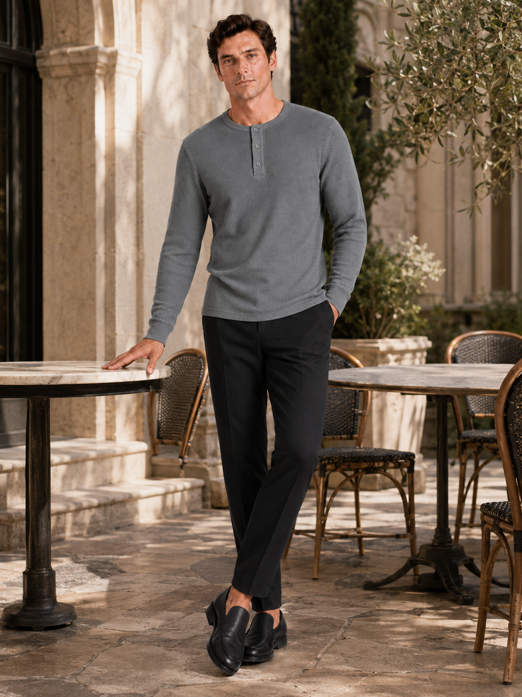 Man styling gray waffle knit henley shirt in a clean weekend lifestyle outfit