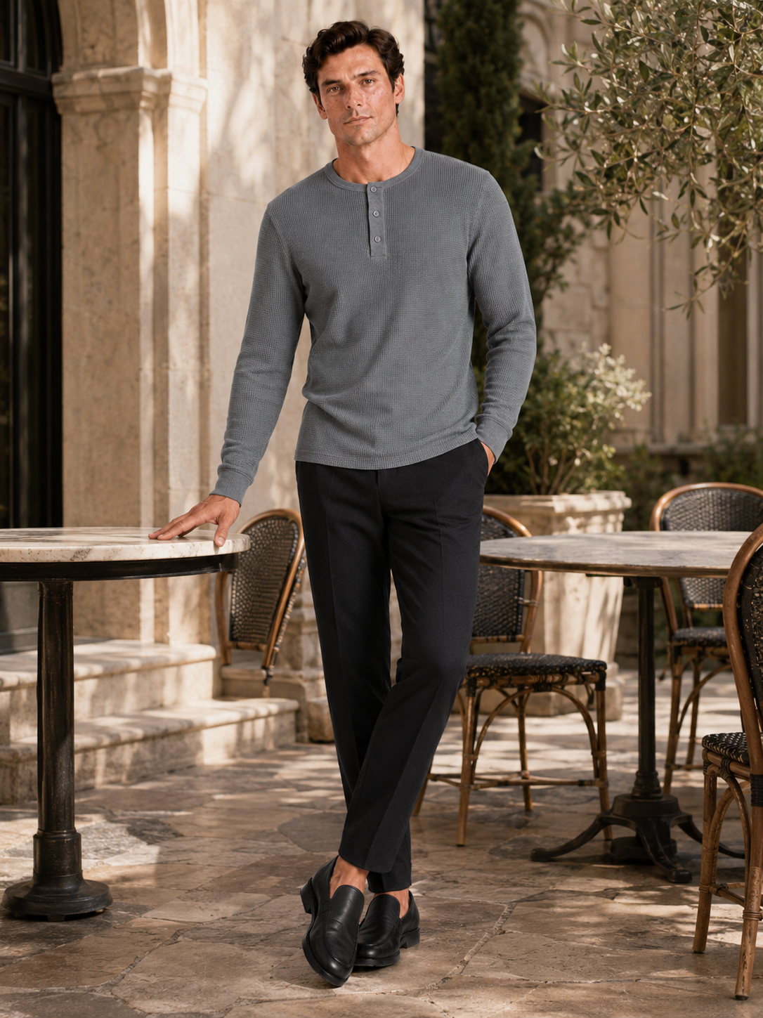 Man styling gray waffle knit henley shirt in a clean weekend lifestyle outfit