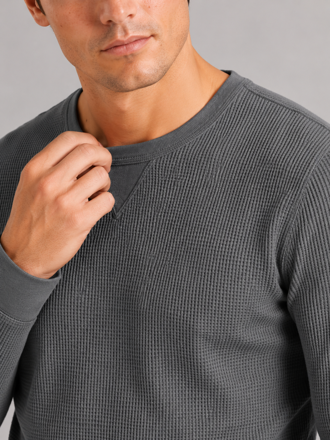 Close up of gray waffle knit shirt showing textured thermal fabric and soft knit detail