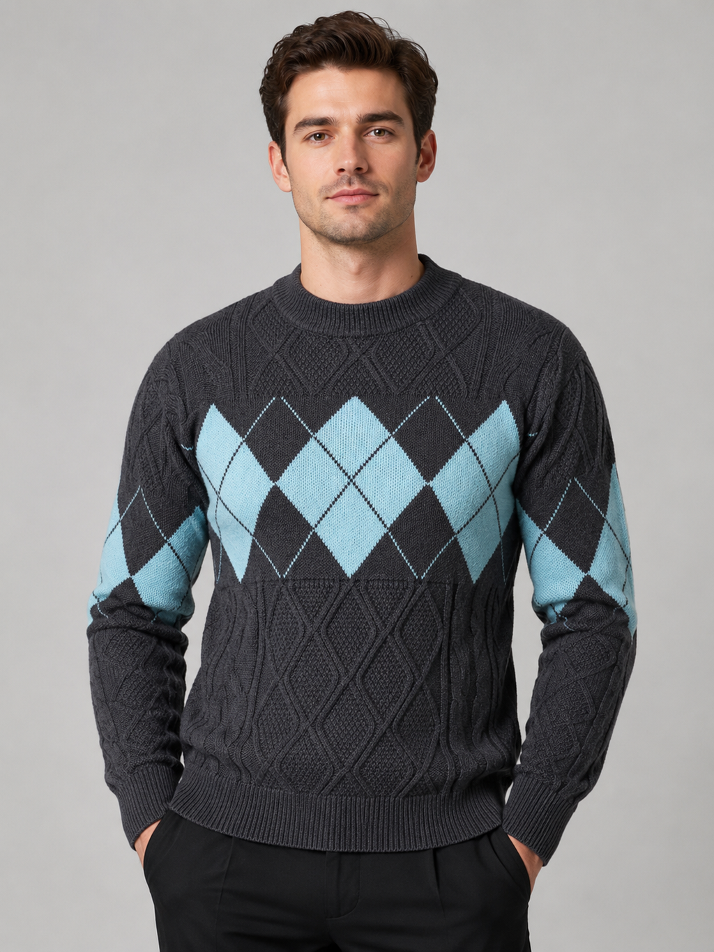 Front view of a man wearing a gray argyle cable knit sweater with a mock neck, patchwork design, long sleeves, and warm knit construction