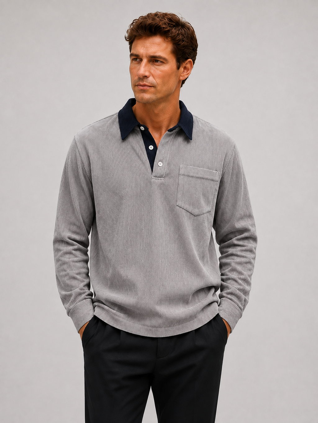 Front view of a man wearing a gray corduroy long sleeve polo shirt with a contrast turn-down collar and relaxed fit