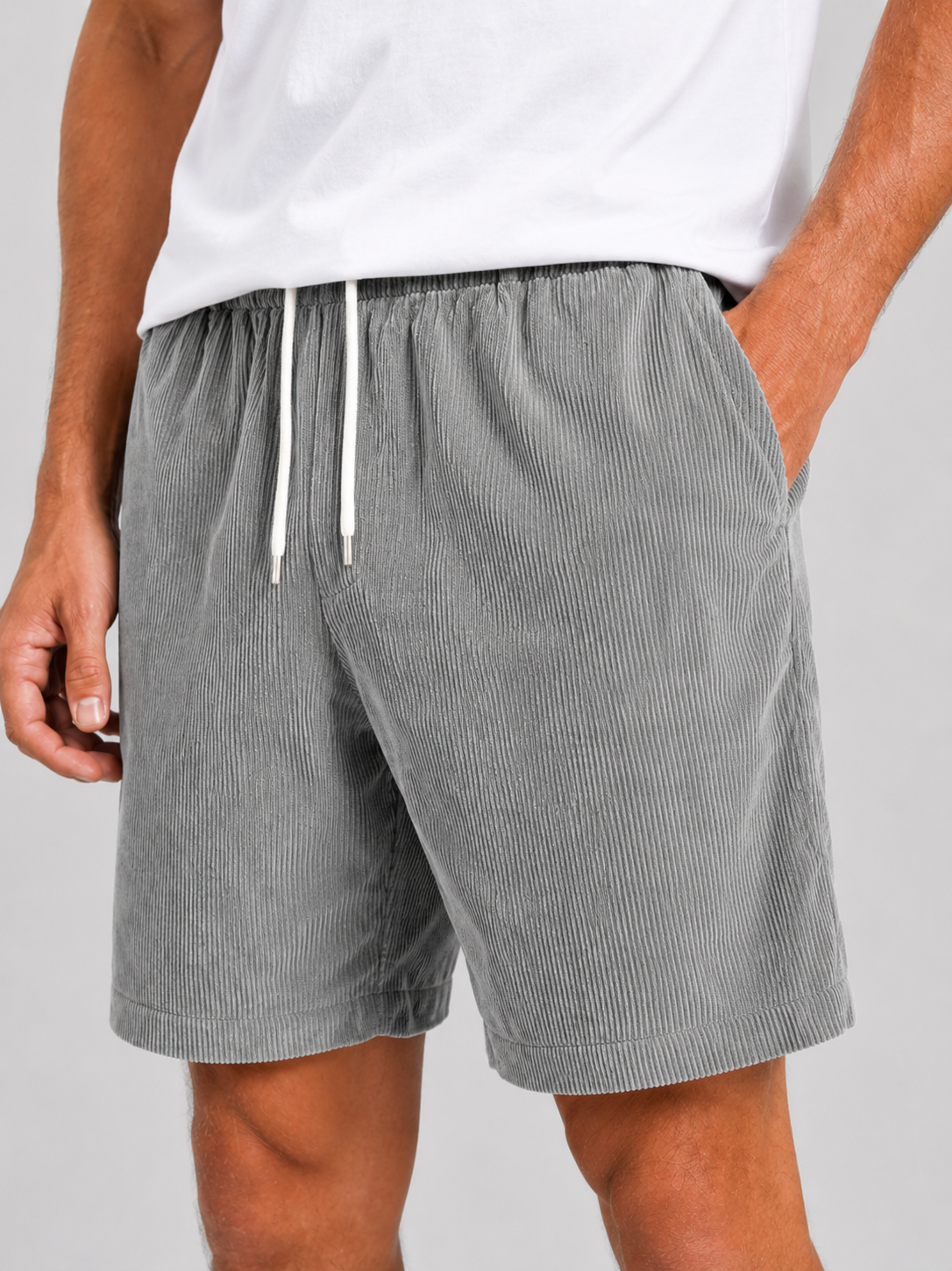 Man styling black corduroy shorts in a modern beach and outdoor lifestyle outfit