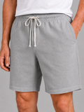 Close up of gray waffle texture shorts showing breathable fabric and adjustable drawstring waistband