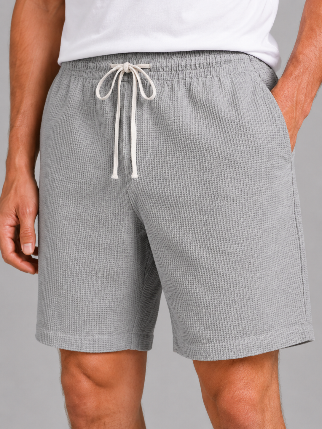 Close up of gray waffle texture shorts showing breathable fabric and adjustable drawstring waistband