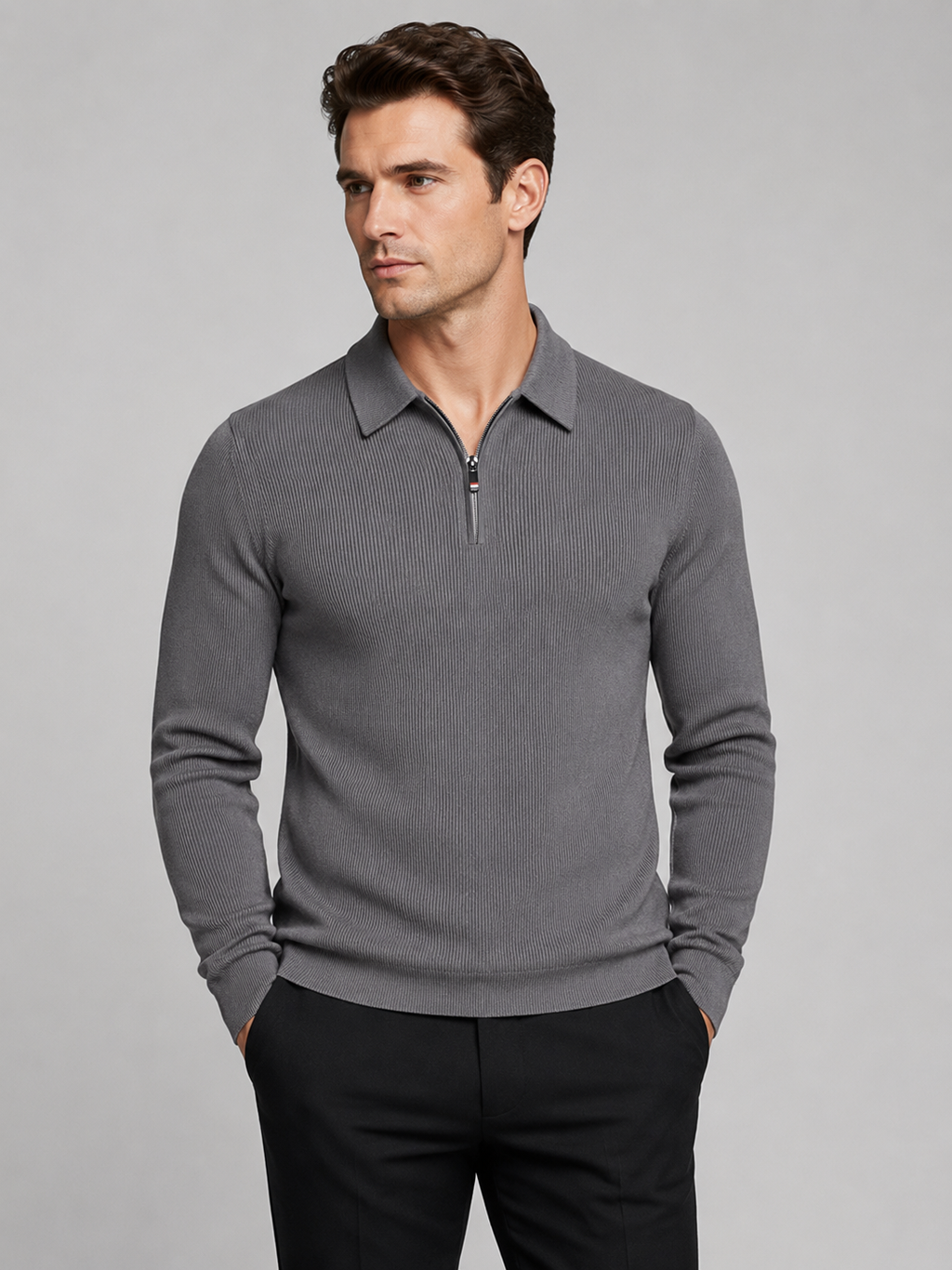 Front view of a man wearing a gray quarter zip long sleeve polo with a lapel collar and tailored business casual fit