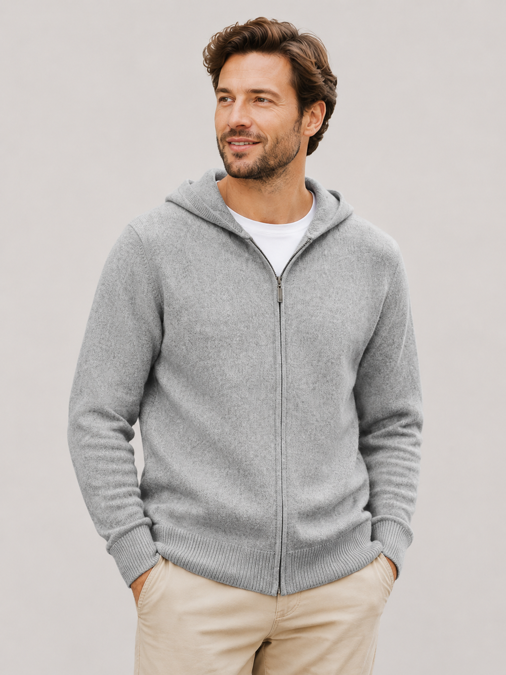 Front view of a man wearing a gray wool cardigan hoodie with a full zip front, thick knit construction, and long sleeves
