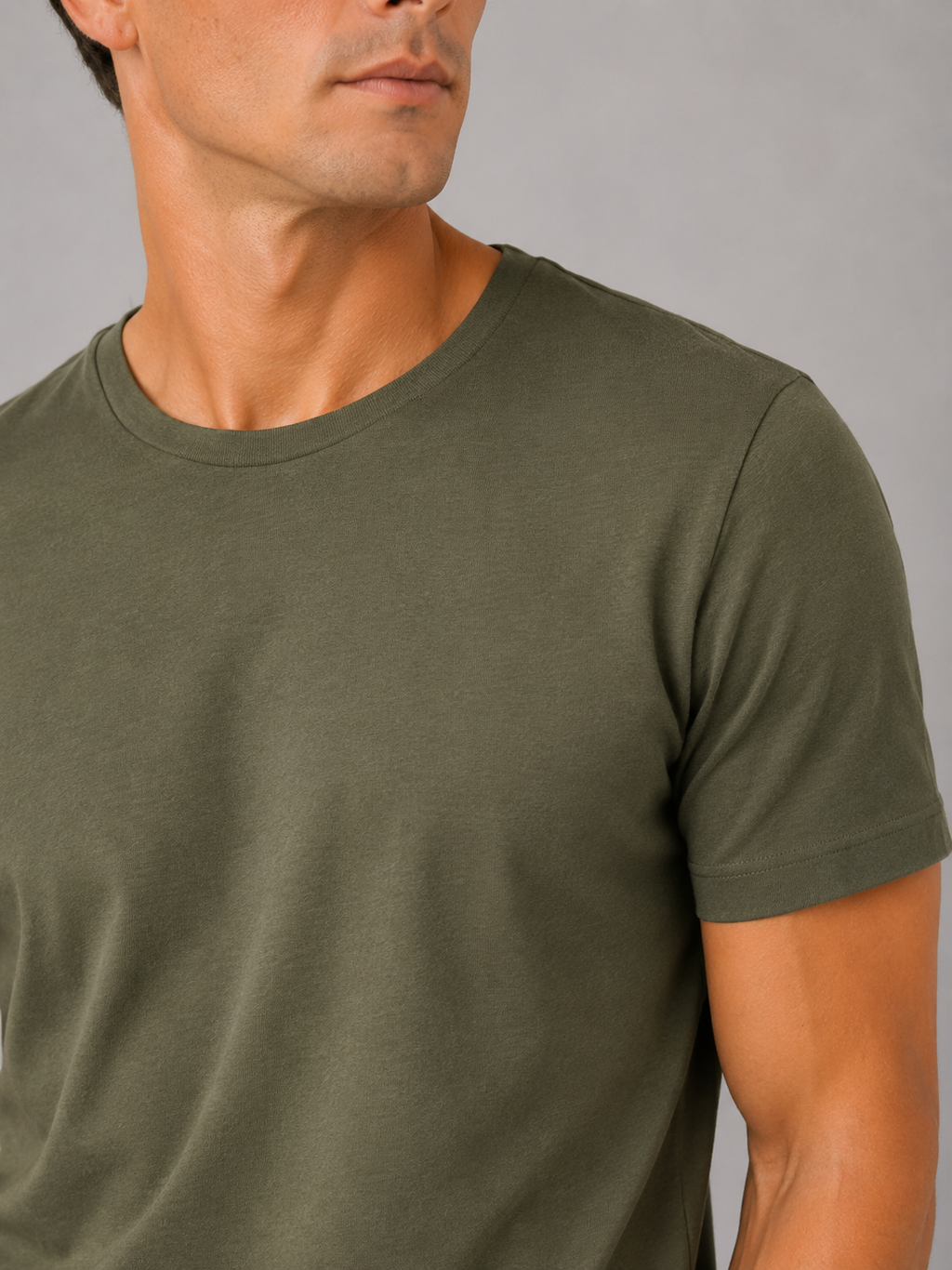 Close up of green cotton t shirt showing soft breathable fabric and clean crew neck detail