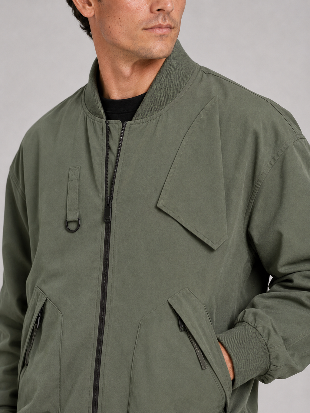 Close up of green bomber jacket showing durable fabric and ribbed collar detail