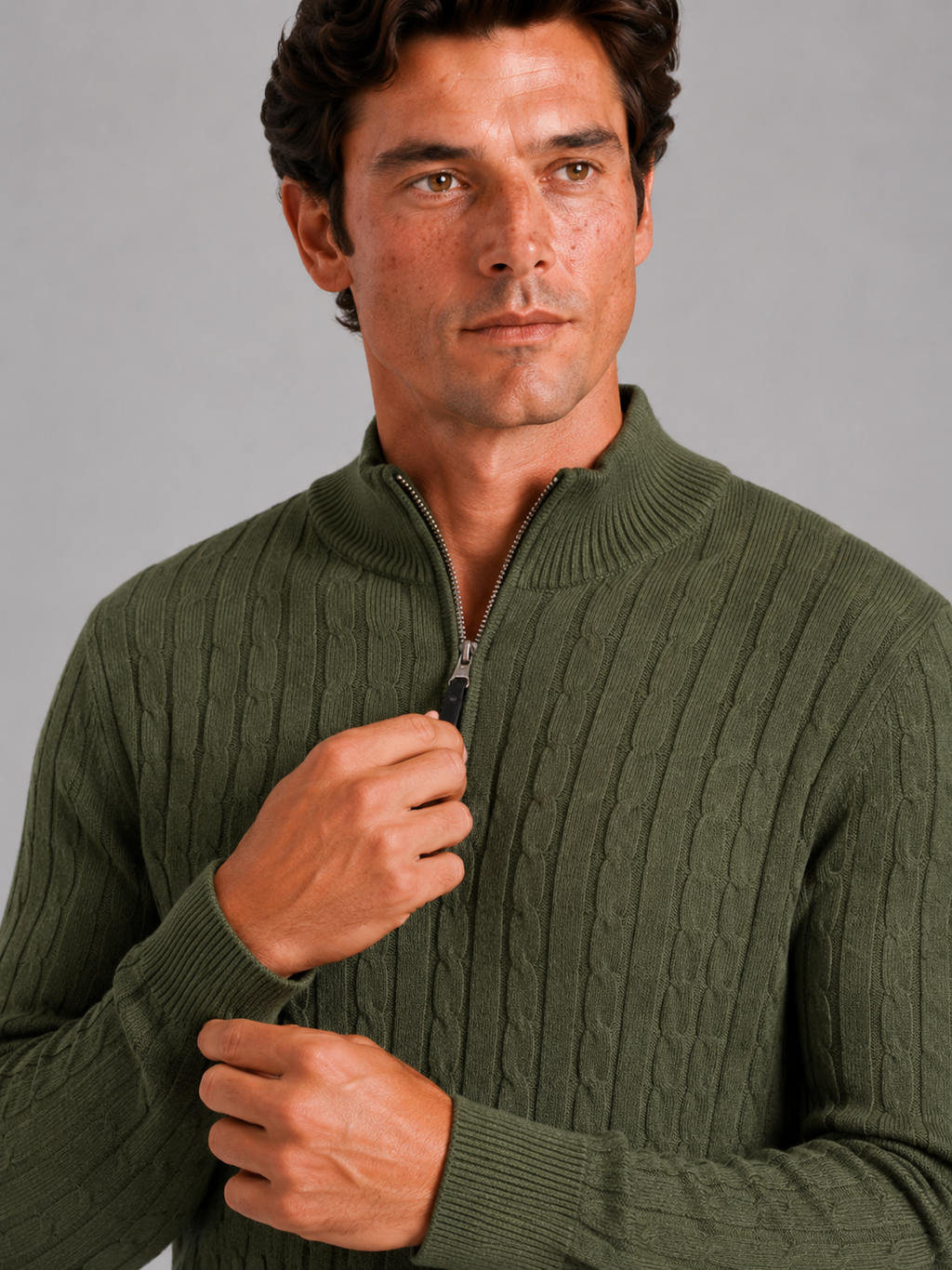 Close up of green cable knit sweater showing thick textured fabric and quarter zip detail