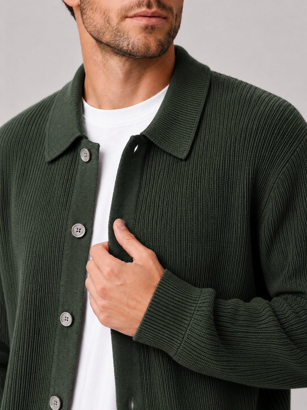 Close up of green knit cardigan showing soft textured fabric and relaxed lapel collar detail