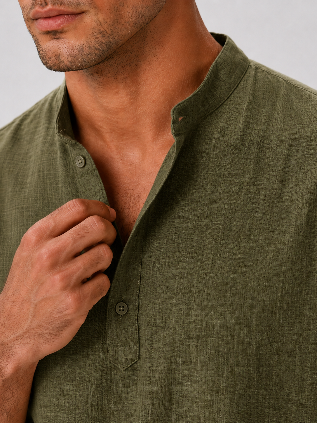 Close up of green band collar shirt showing soft breathable fabric and button up detail