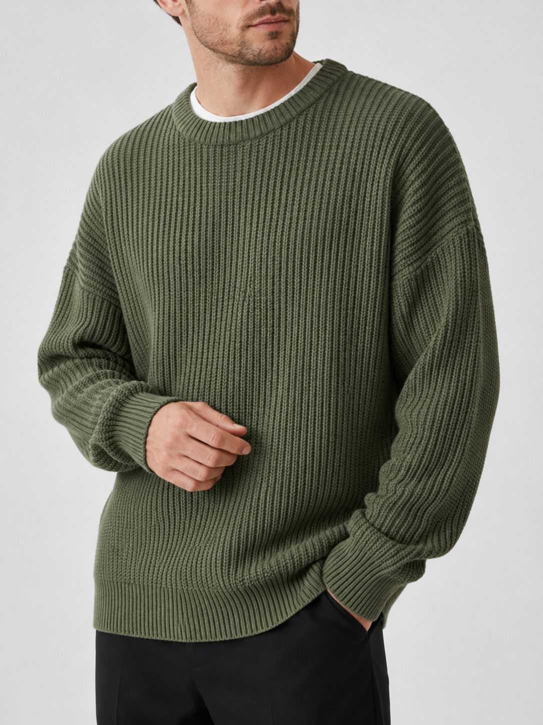 Close up of green crewneck sweater showing soft knit texture and classic ribbed neckline detail