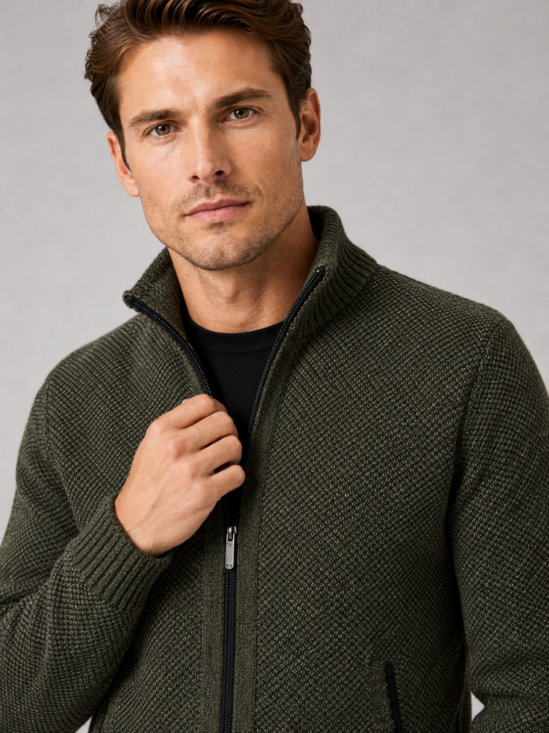 Close up of green fleece cardigan showing soft knit texture, full zip front, and warm fleece lining detail