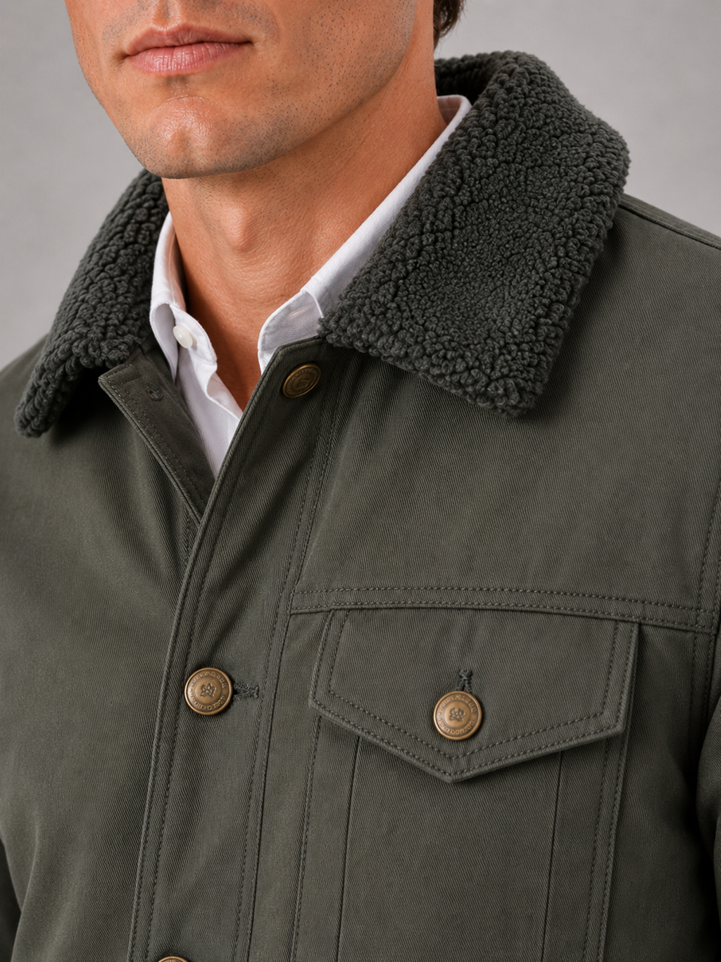 Close up of green winter jacket showing soft fur collar and insulated fleece lined construction