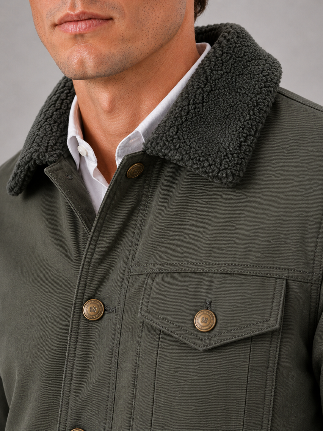Close up of green winter jacket showing soft fur collar and insulated fleece lined construction