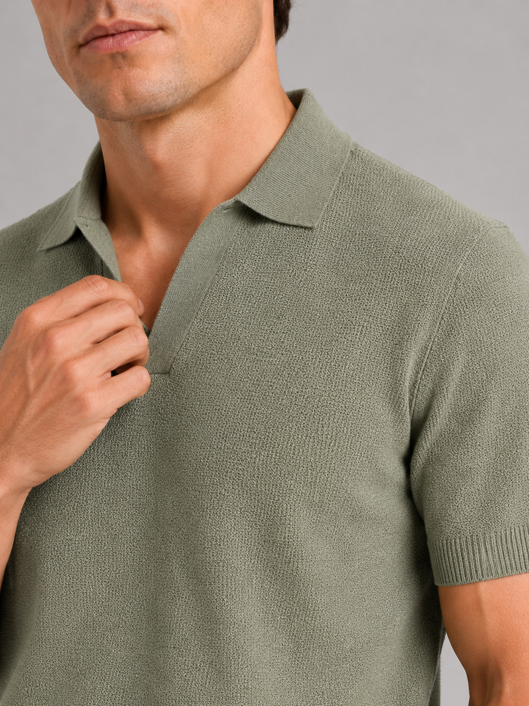 Close up of green knit polo t shirt showing soft breathable fabric and refined collar detail
