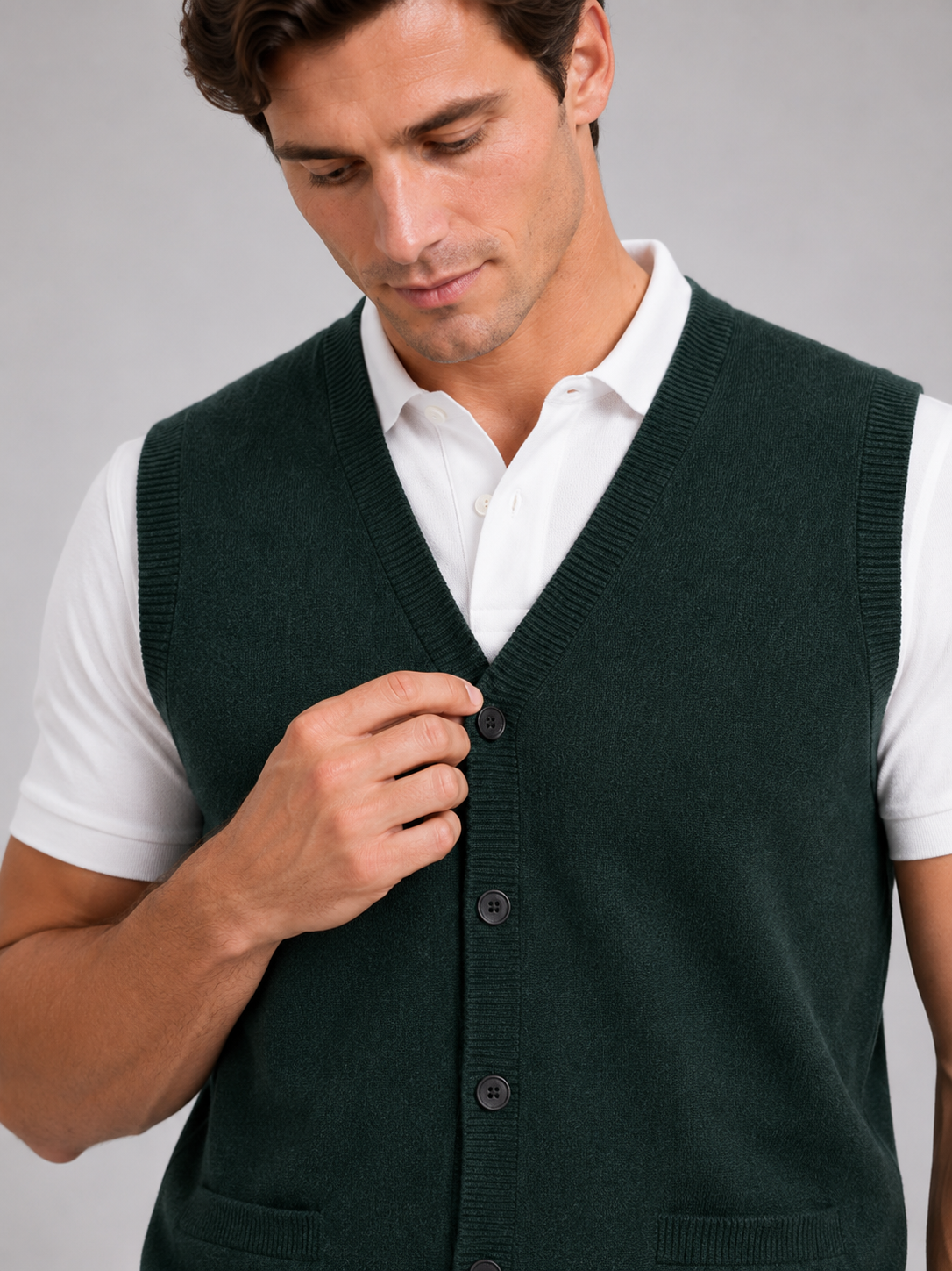 Close up of green button up sweater vest showing soft knit texture and classic v neck detail
