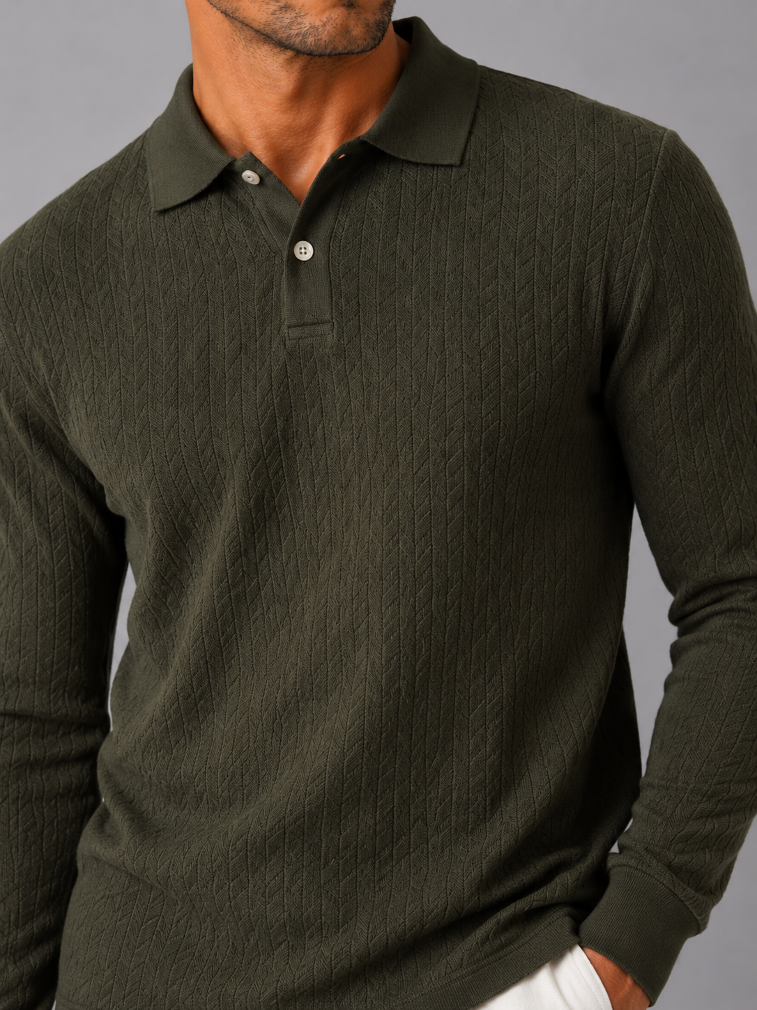 Close up of green knit polo shirt showing soft textured fabric and refined collar detail