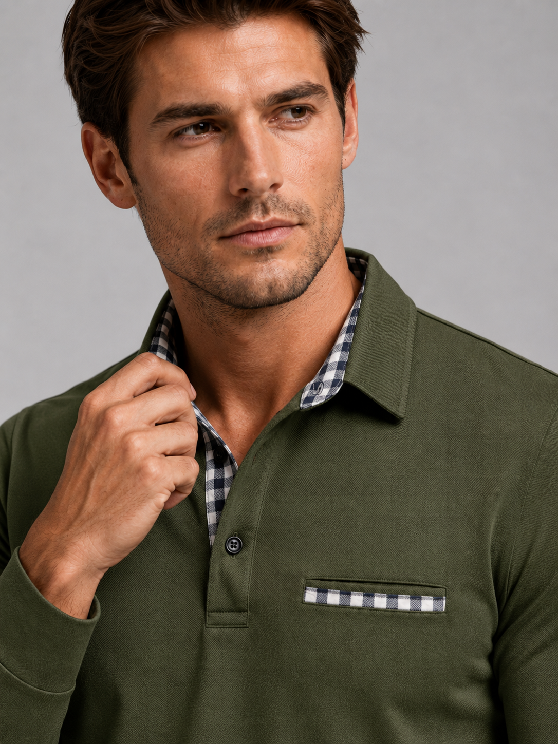 Close up of green polo shirt showing plaid panel detail, soft fabric, and classic collar