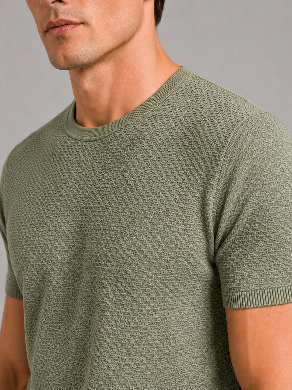 Close up of green mesh t shirt showing breathable texture and soft stretch fabric detail