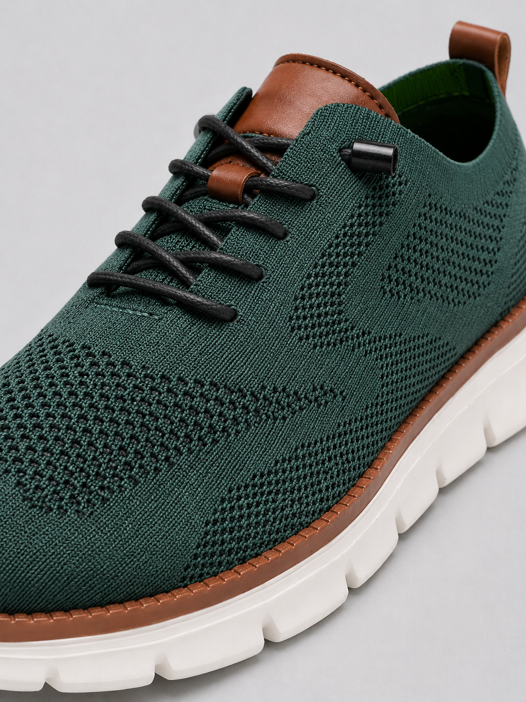 Close up of green mesh sneakers showing breathable knit upper and cushioned sole detail