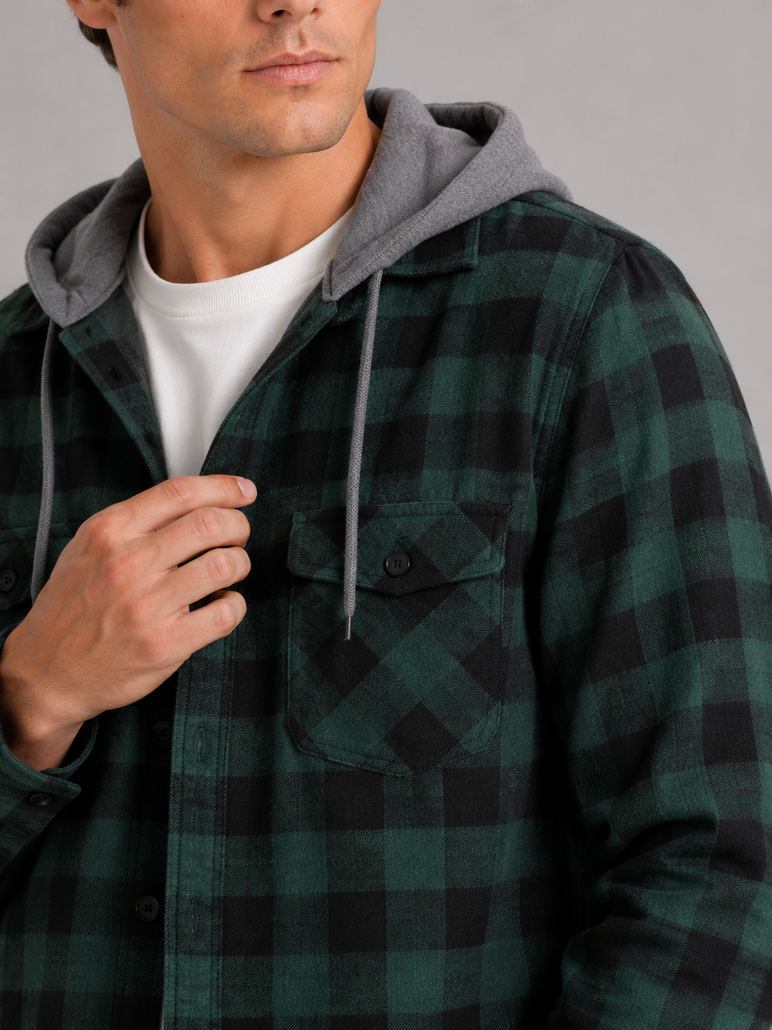 Close up of green plaid flannel jacket showing soft brushed fabric and hood detail