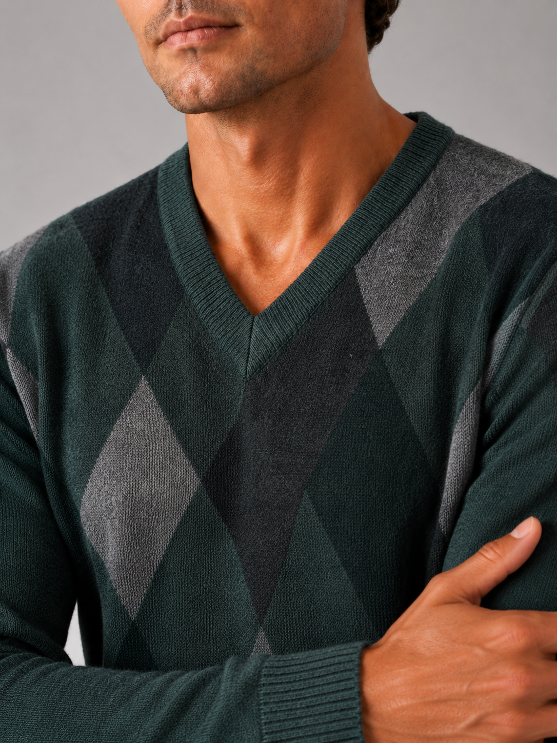 Close up of green plaid knit sweater showing soft textured fabric and refined v neck detail