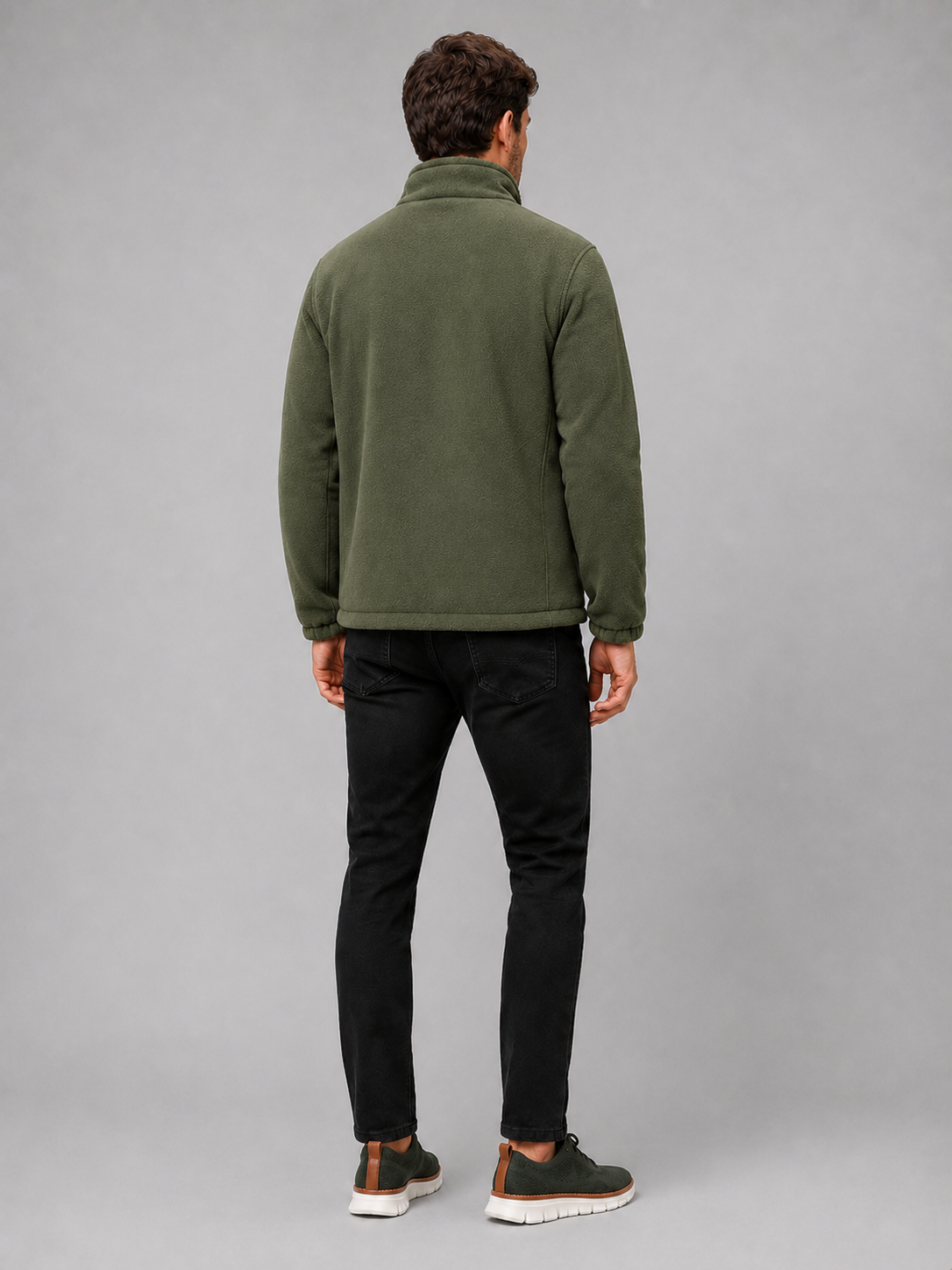 Back view of a man wearing a green polar fleece jacket showing the stand collar, long sleeves, thick fleece construction, and comfortable outdoor fit