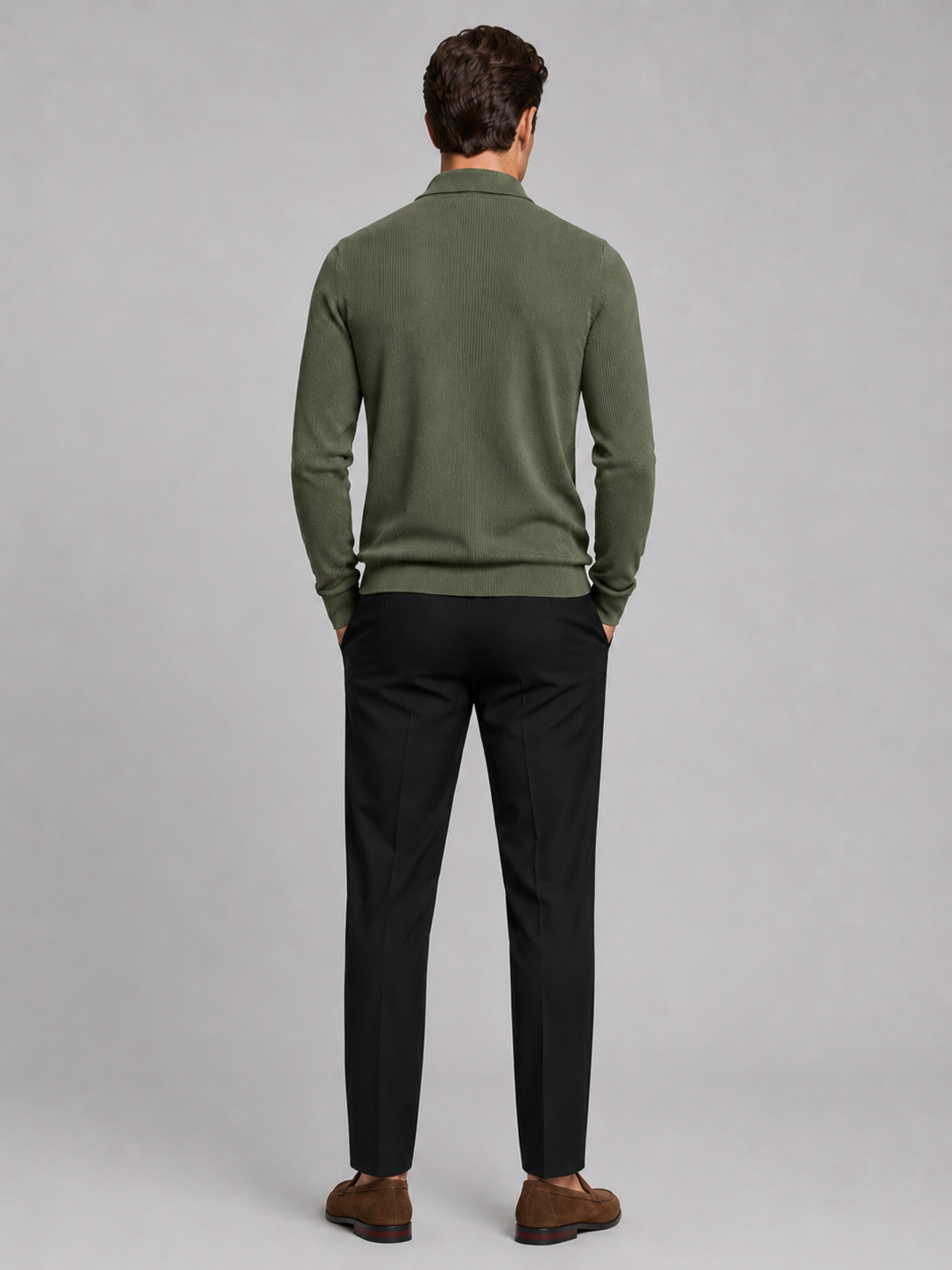 Back view of a man wearing a green quarter zip polo showing the long sleeves, structured collar, and comfortable fall fit